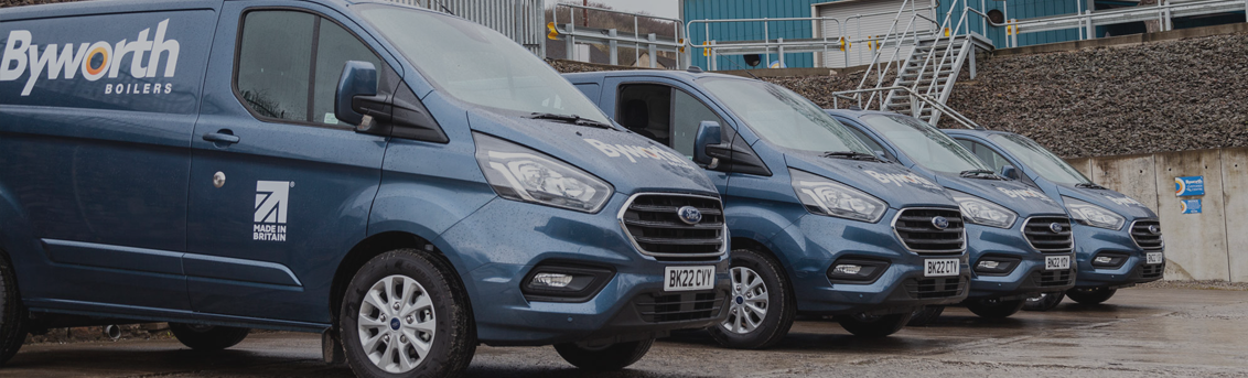 Four blue ford transit vans lined up all displaying the Byworth Boilers logo 