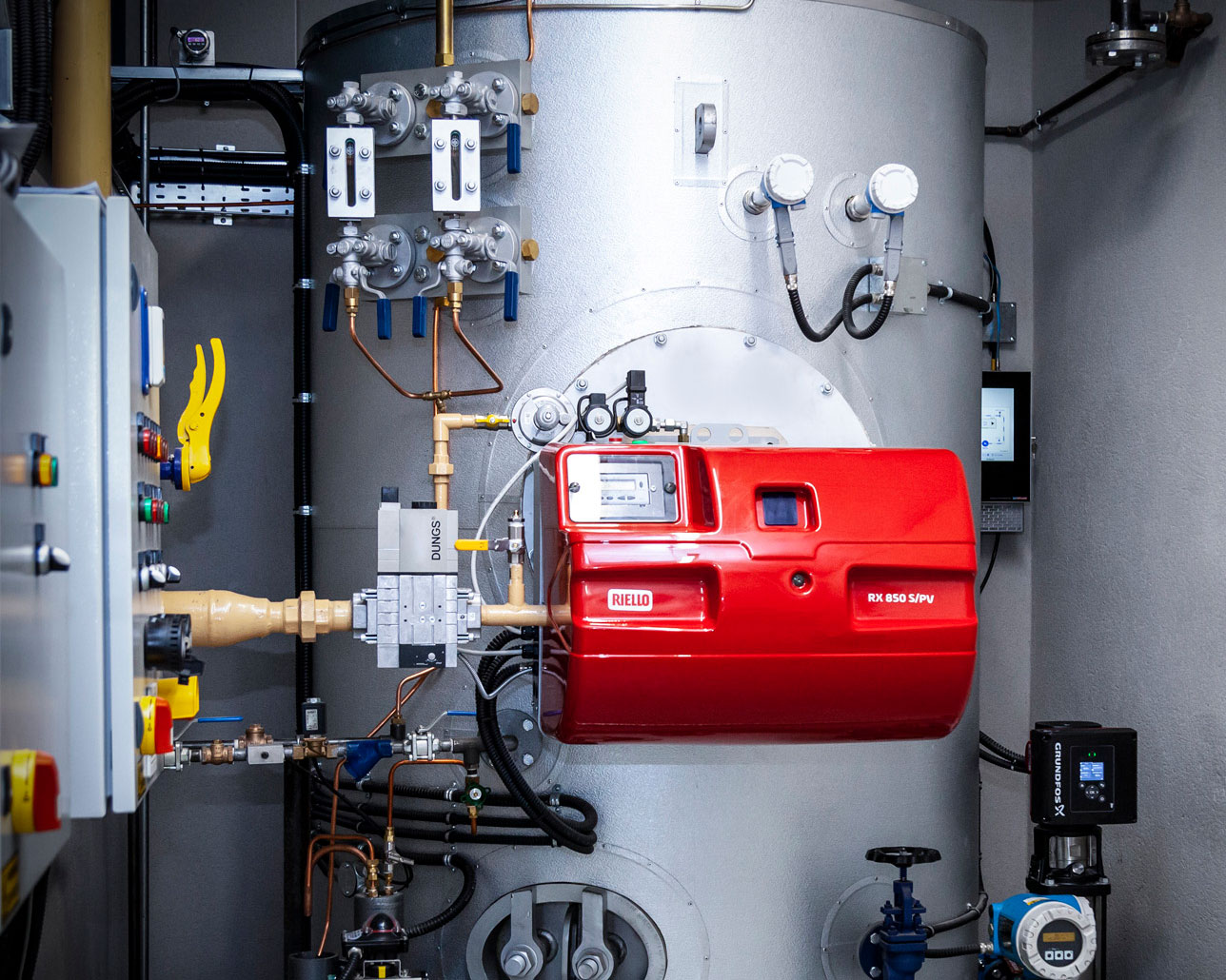 Close up of mud lid and pump on a vertical steam boiler